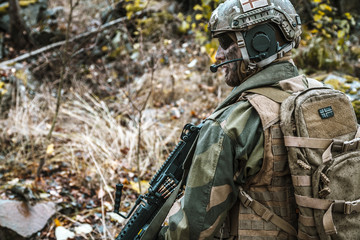 Norwegian Rapid reaction special forces FSK soldier patrolling in the forest. Field camo uniforms,...