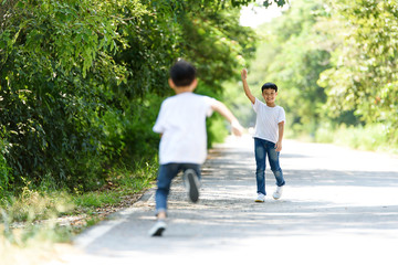 Obraz premium Two boy run in the park