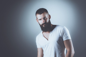Portrait of handsome man standing, isolated on grey background