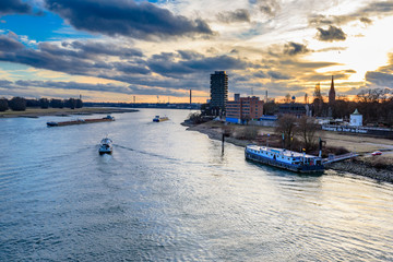 Sunset or sunrise over the rhine with ships and iconic landmarks