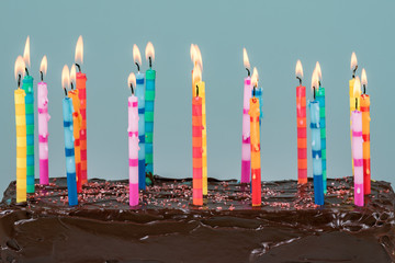 Twenty one birthday candles on a chocolate cake with a shallow depth of field