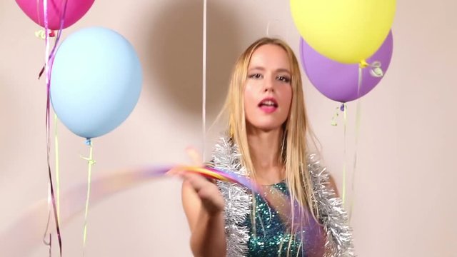 Cute blonde woman playing with hula hoop in photo booth 