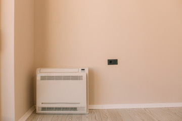 Square air conditioner in the apartment. On the floor, split system.