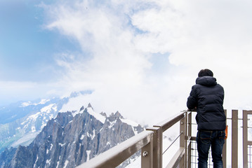 Asian tourist look at Mont blanc massif.