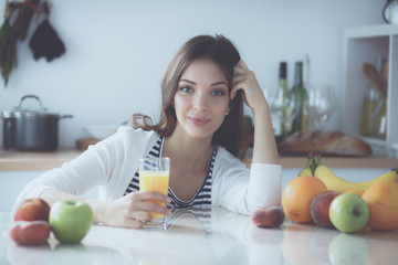 Obraz na płótnie Canvas Portrait of a pretty woman holding glass with tasty juice
