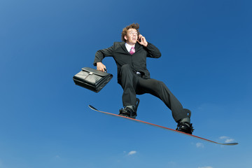 A snowboarder gets ready to leave the office and hit the slopes.