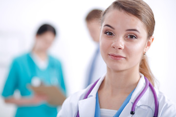 Woman doctor standing with folder at hospital