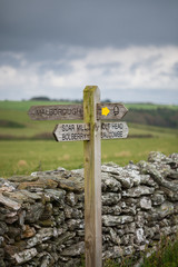 Wooden sign post for the South West Coast Path on the coast near Hope Cove, Bolberry and Cop Soar, Devon, England, UK