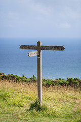 Wooden sign post for the South West Coast Path on the coast near Hope Cove, Bolberry and Cop Soar, Devon, England, UK