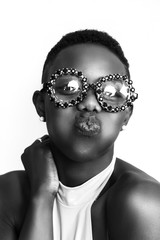 African girl kissing face while wearing funny glasses monochrome