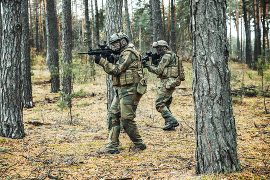Pair of norwegian Rapid reaction special forces FSK soldiers in field uniforms in action in the forest