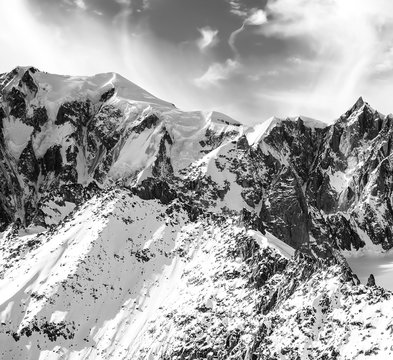 Fototapeta Beautiful snowy mountain peaks in North Italy and cloudscape monochrome