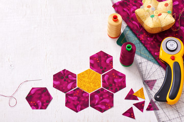 Preparation of hexagon pieces of fabric for sewing a quilt Grandmother's Flower Garden - obrazy, fototapety, plakaty