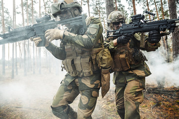 Norwegian Rapid reaction special forces FSK soldiers in field uniforms in action in the forest fog...