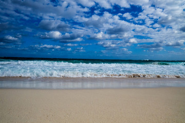 A nice tropical beach view of the ocean with clouds in the sky. New Providence, Nassau, Bahamas.