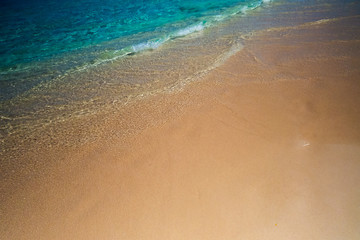 Fototapeta na wymiar A crystal clear creamy wave on the beach. New Providence, Nassau, Bahamas.