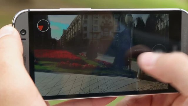 Person viewing 360 image of city square, looking at place on map in mobile app