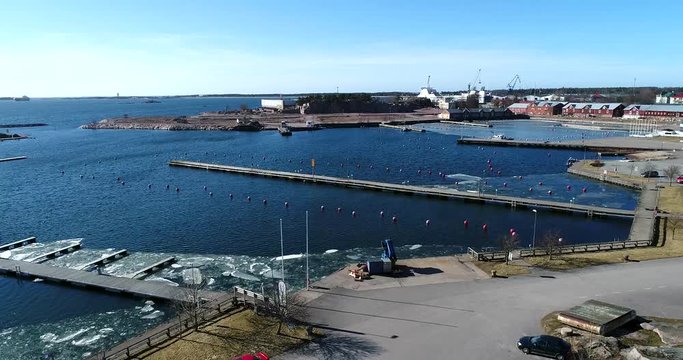 Hanko, Cinema 4k aerial flight above the sea in itasatama, on a sunny spring day, in Hango, Finland