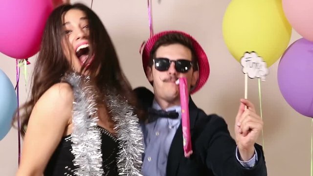 Funny crazy couple having fun in photo booth