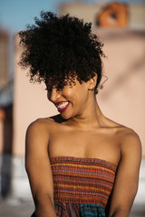 Fototapeta na wymiar Beautiful curly hair girl smiling and enjoying the weather