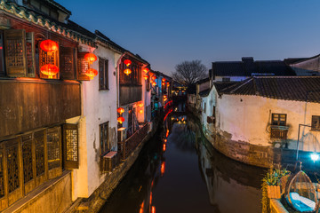 Fototapeta na wymiar Traditional old riverside houses illuminated at night in Shantang water town, Suzhou, Jiangsu Province, China, Asia