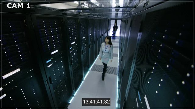 Security Camera N1 Footage of Asian Female IT Specialist and Caucasian Male Server Engineer Who Pushes Crash Cart. They're Working in Big Data Center. Shot on RED EPIC-W 8K Helium Cinema Camera.