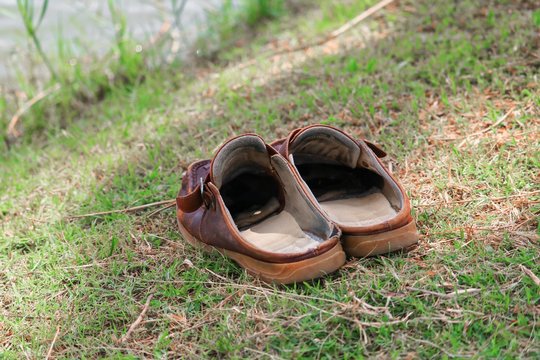 brown shoes leather old on grass select focus with shallow depth of field.