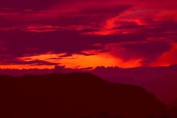 sunset in sky and cloud, beautiful colorful twilight time with mountain silhouette