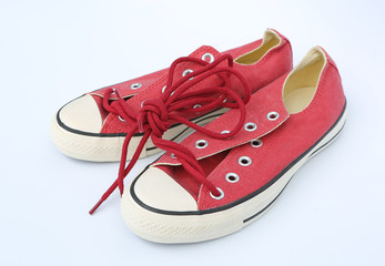 Pair of new red sneakers isolated on white background