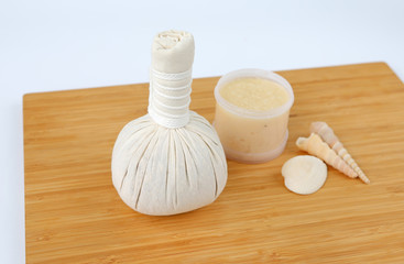 Spa herbal compressing ball and Salt Scrub, Spa concept on bamboo board against white background