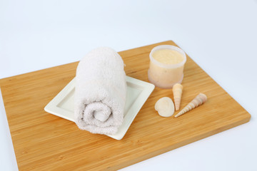 Spa concept, Towels and Salt Scrub on bamboo board against white background