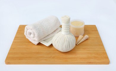 Spa herbal compressing ball with towels and Salt Scrub, Spa concept on bamboo board against white...