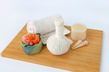Fototapeta na wymiar Spa herbal compressing ball with towels and Salt Scrub, Spa concept background