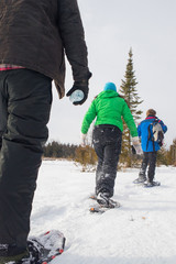 Small group of people snowshoeing in Ontario Canada on a frozen lake