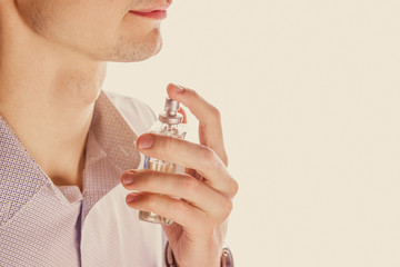 Man applying perfume on his neck