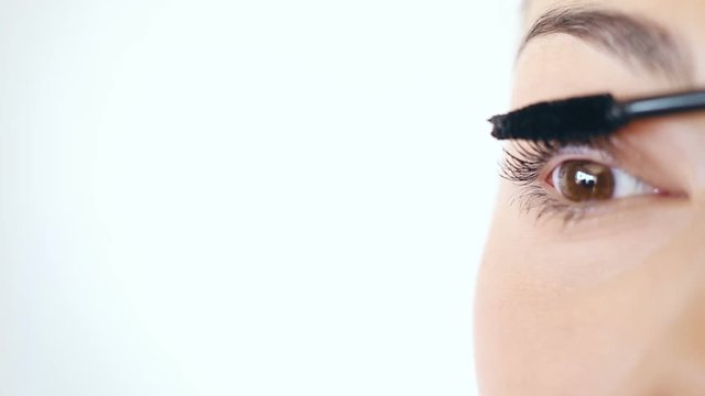 Close up of mascara applying, Macro shot of woman applying mascara.