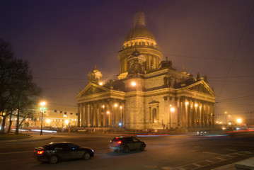 St. Isaac's Cathedral in the urban landscape of foggy March night. Saint-Petersburg