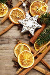 Christmas background with cinnamon sticks, dried oranges and fir branch.