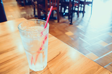 glass of water on wood table in restaurant