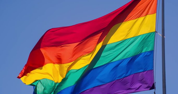 Slow motion gay pride flag blowing in the wind.