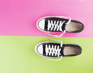 pair of canvas shoes on two tone colorful background