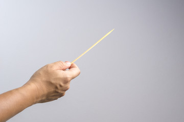 Hand holding empty wooden stick