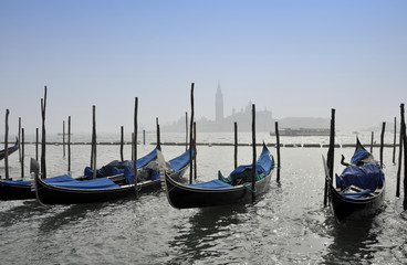 Fototapeta na wymiar Gondolas in Canal Grande with San Giorgio maggiore island