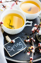 Green tea and peach blossom as a spring concept