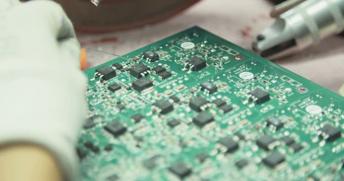 Manual soldering of components into a board