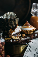 Chocolate Tartlets with nuts and Italian meringue