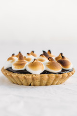 Chocolate Tartlets with nuts and Italian meringue