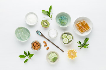 Herbal dermatology cosmetic hygienic cream for beauty and skincare product. honey, lemon, almond, kiwi, cucumber, aloe vera, salt, yogurt on white background.
