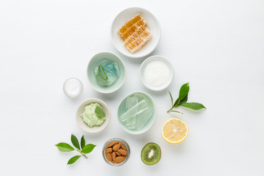 Herbal dermatology cosmetic hygienic cream for beauty and skincare product. honey, lemon, almond, kiwi, cucumber, aloe vera, salt, yogurt on white background.