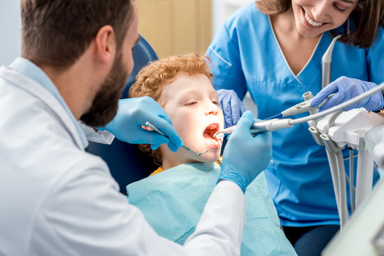 Young boy during the dental procedure at the dental office